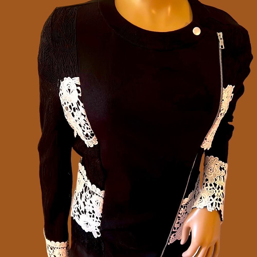 Gorgeous black sweater top with white lace embellishments.
